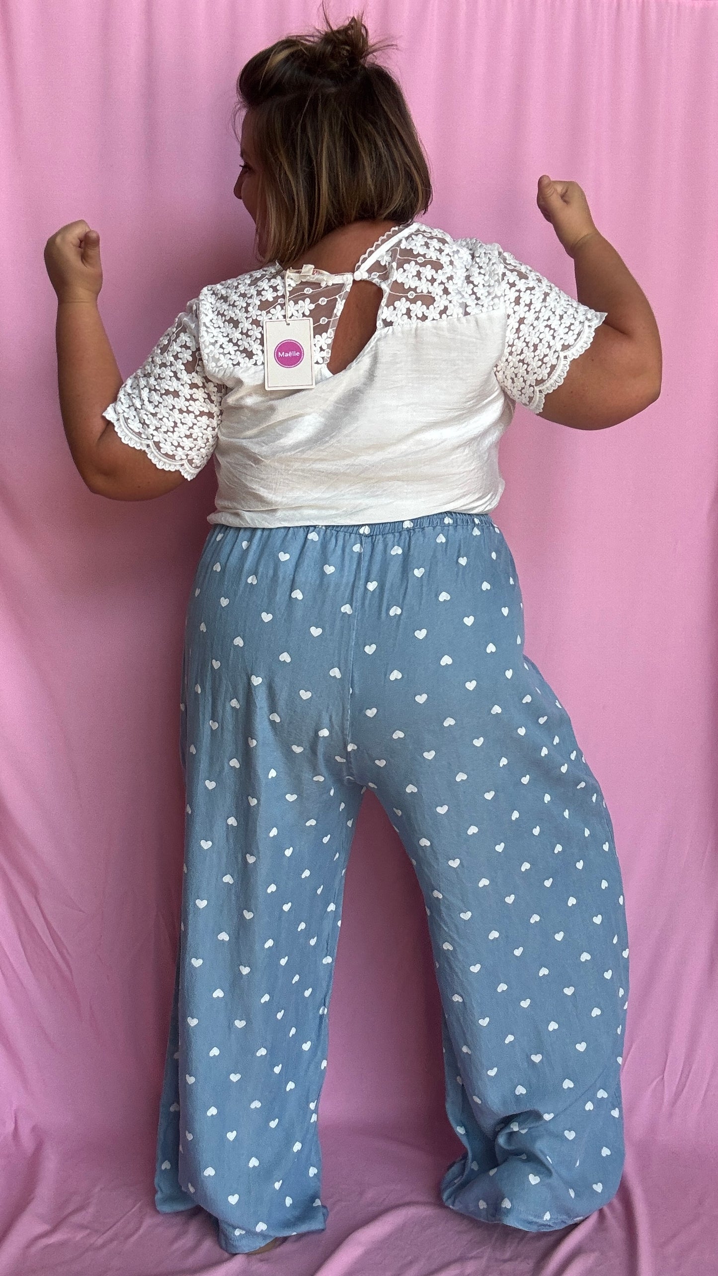 Avec sa coupe droite et jambes larges, ce pantalon fluide bleu ciel motifs coeur blanc est parfait pour bouger librement tout en étant stylée.