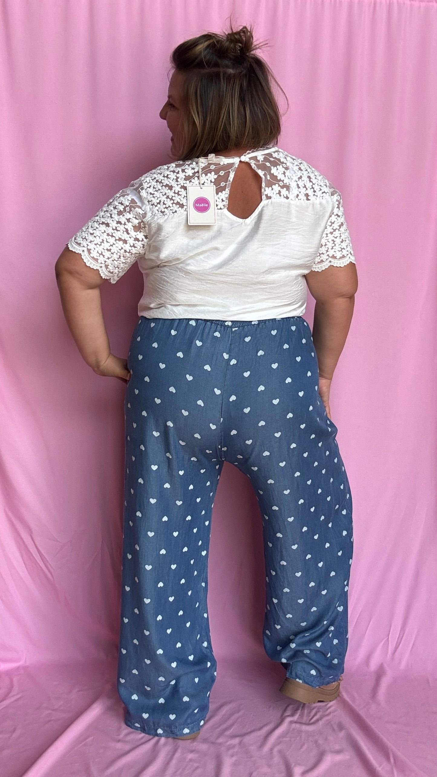 Avec sa coupe droite et jambes larges, ce pantalon fluide bleu jean motifs coeur blanc est parfait pour bouger librement tout en étant stylée.