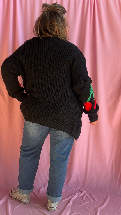 Ajoutez une dose de fun et de style à vos tenues avec ce gilet long grande taille noir, orné de gros motifs cerise sous les coudes pour une touche créative et pleine de pep’s.