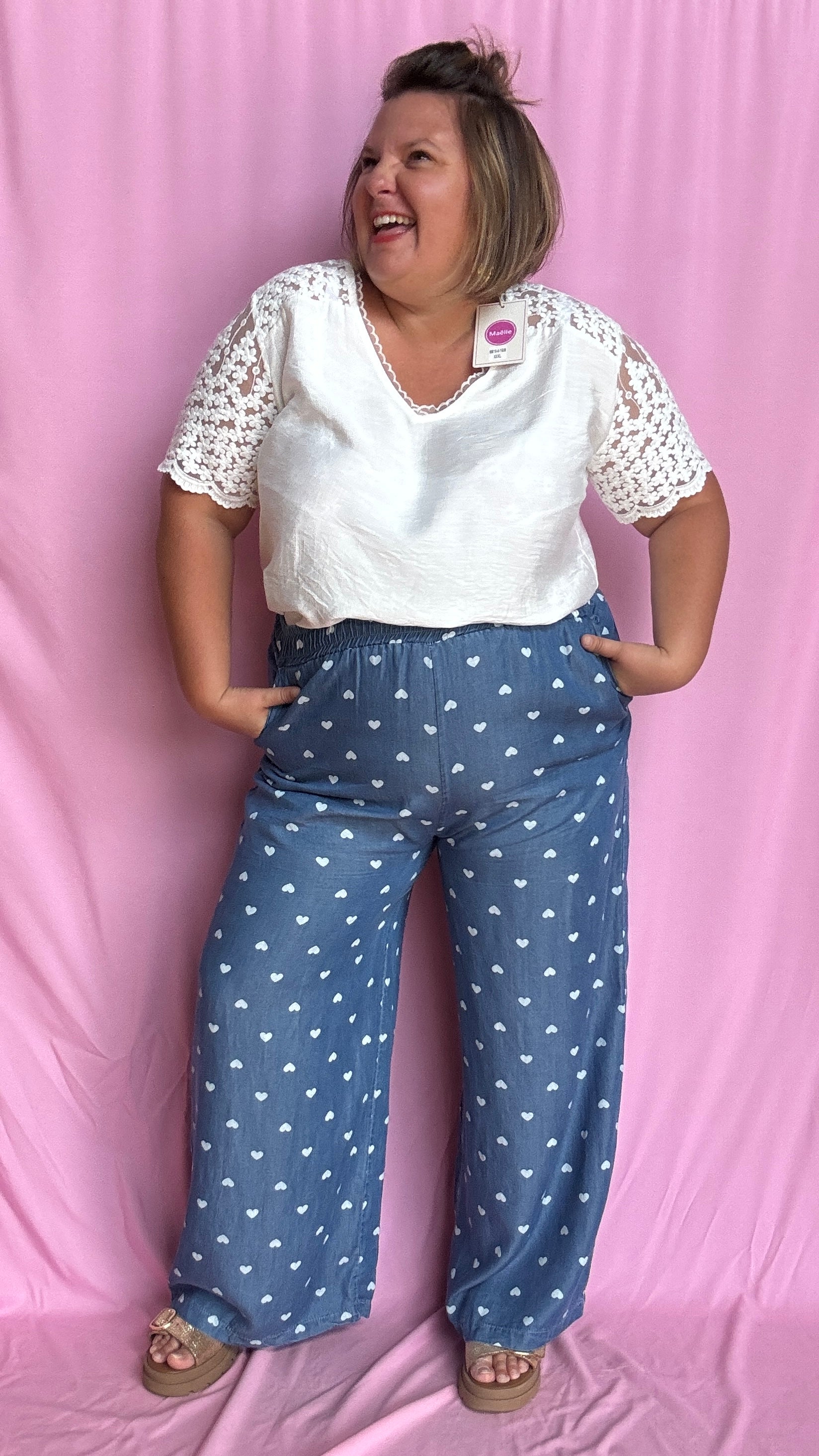 Avec sa coupe droite et jambes larges, ce pantalon fluide bleu jean motifs coeur blanc est parfait pour bouger librement tout en étant stylée.